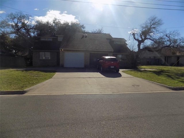 view of front facade with a garage, concrete driveway, a front yard, and a shingled roof