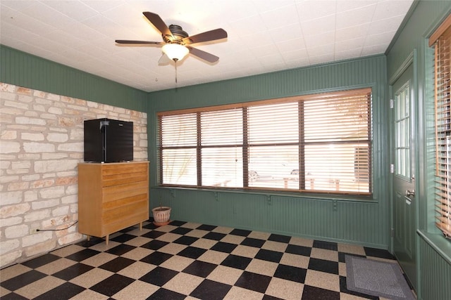 unfurnished living room with ceiling fan