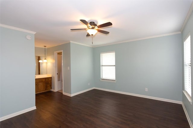 empty room featuring ornamental molding, dark hardwood / wood-style floors, and ceiling fan