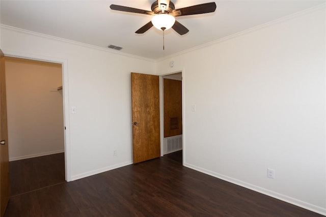 unfurnished room with crown molding, dark wood-type flooring, and ceiling fan