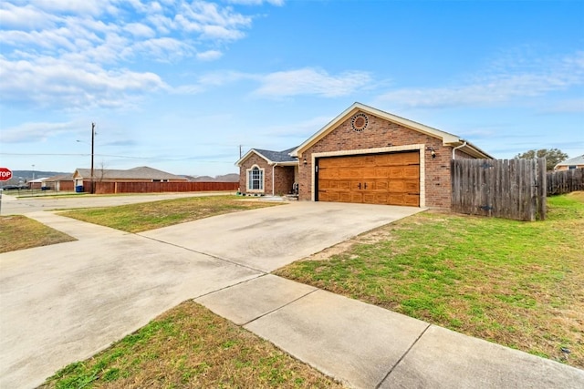 ranch-style home featuring a garage and a front yard