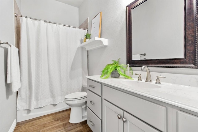 full bathroom featuring shower / tub combo with curtain, vanity, toilet, and hardwood / wood-style floors