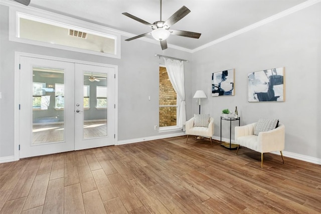 unfurnished room with crown molding, hardwood / wood-style floors, ceiling fan, and french doors