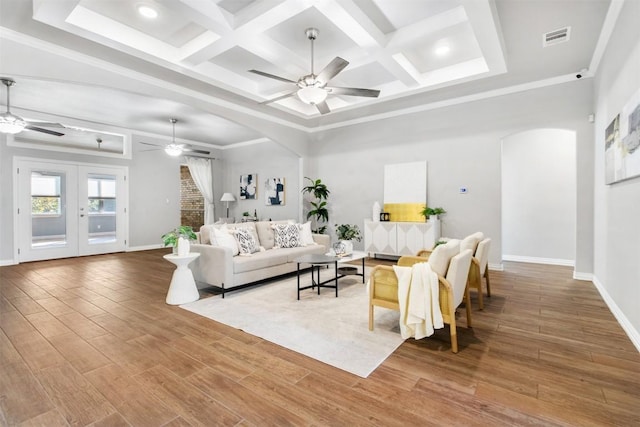 living room featuring french doors, ceiling fan, wood-type flooring, and coffered ceiling