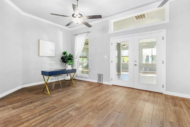 interior space featuring hardwood / wood-style flooring, ornamental molding, ceiling fan, and french doors