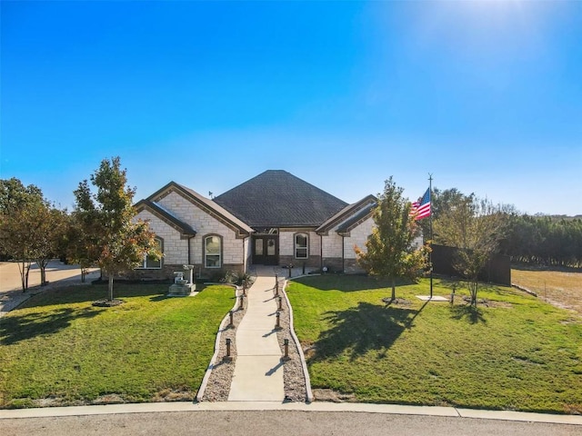 french country home featuring a front yard