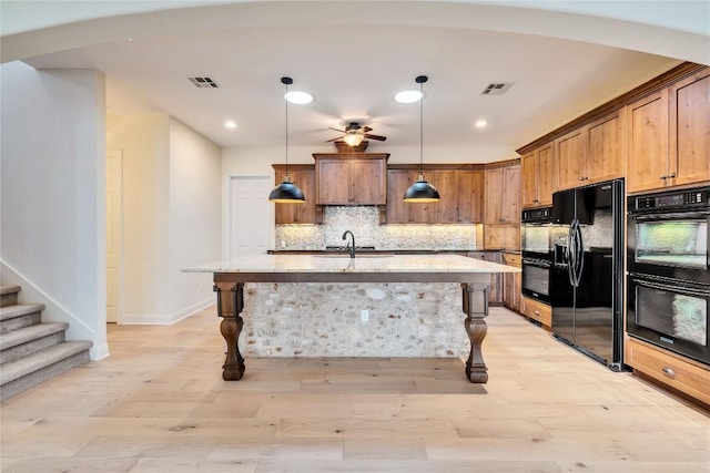 3701 Copper Ridge Ct, Austin, TX 78734 - kitchen featuring black appliances, a kitchen breakfast bar, light stone countertops, decorative backsplash, and recessed lighting
