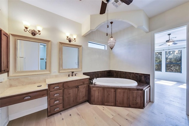 3701 Copper Ridge Ct, Austin, TX 78734 - bathroom with a ceiling fan, wood finished floors, a garden tub, and vanity