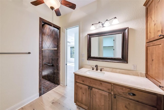 3701 Copper Ridge Ct, Austin, TX 78734 - bathroom with wood finished floors, vanity, tiled shower, and ceiling fan