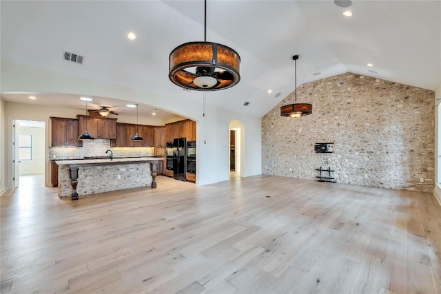 3701 Copper Ridge Ct, Austin, TX 78734 - unfurnished living room with arched walkways, high vaulted ceiling, ceiling fan, light wood-type flooring, and recessed lighting