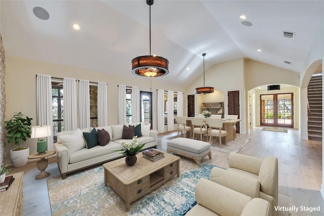 3701 Copper Ridge Ct, Austin, TX 78734 - living area featuring arched walkways, healthy amount of natural light, light wood-style flooring, recessed lighting, and high vaulted ceiling