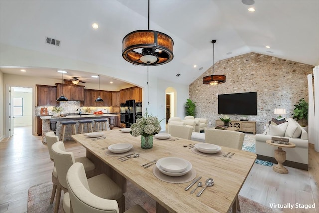3701 Copper Ridge Ct, Austin, TX 78734 - dining area with arched walkways, vaulted ceiling, light wood-style floors, recessed lighting, and ceiling fan