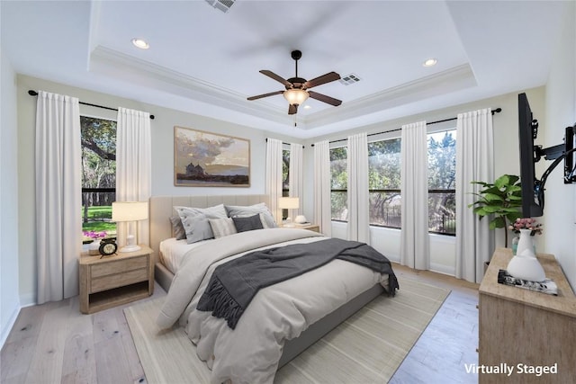 3701 Copper Ridge Ct, Austin, TX 78734 - bedroom with a tray ceiling, multiple windows, light wood-style floors, ornamental molding, and recessed lighting