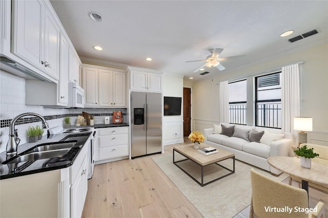 3701 Copper Ridge Ct, Austin, TX 78734 - kitchen with stainless steel refrigerator with ice dispenser, a sink, white microwave, light wood-style flooring, and white cabinets