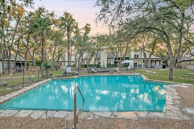 view of pool at dusk