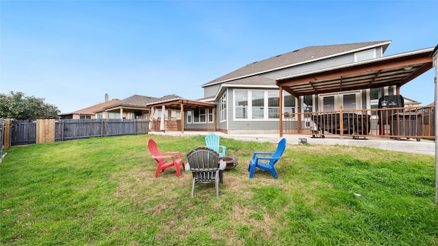 rear view of house featuring a lawn and a fire pit