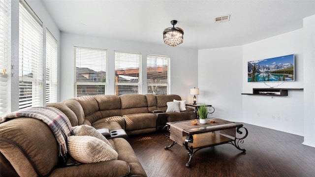 living room featuring dark hardwood / wood-style floors and a chandelier