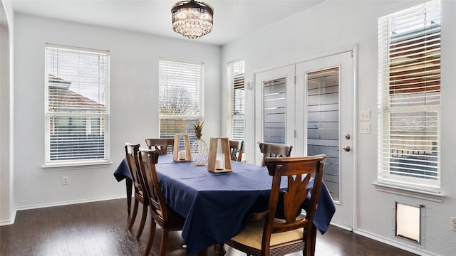 dining space featuring an inviting chandelier and dark hardwood / wood-style floors