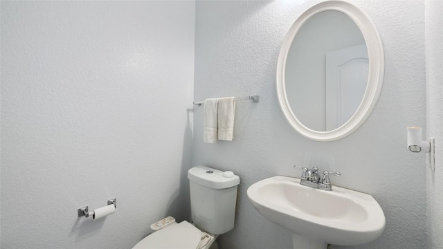 bathroom featuring toilet and sink