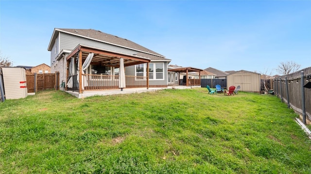 rear view of house with a lawn and a storage unit