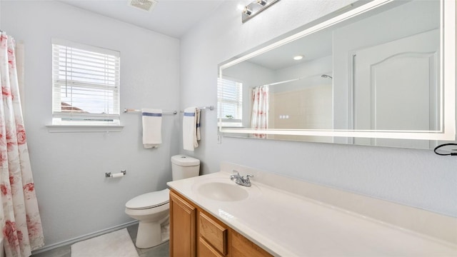 bathroom featuring walk in shower, vanity, and toilet