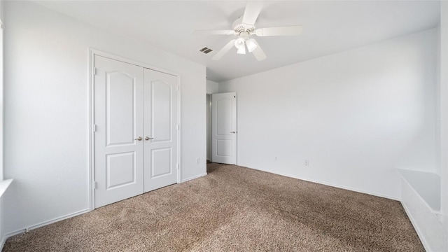 unfurnished bedroom with carpet flooring, ceiling fan, and a closet