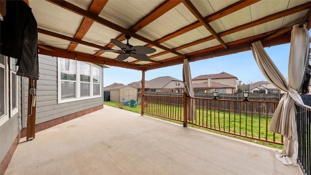 view of patio / terrace with ceiling fan and a storage shed