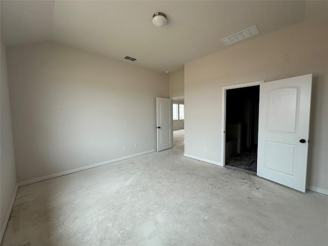 unfurnished bedroom with lofted ceiling, visible vents, concrete floors, and baseboards