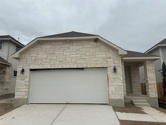 single story home featuring a garage, stone siding, a shingled roof, and driveway