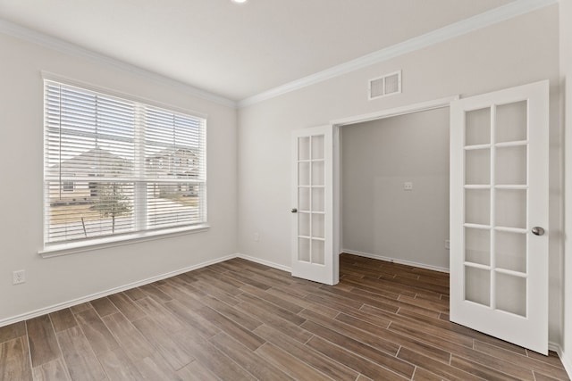 spare room featuring crown molding and french doors