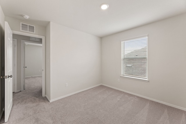 unfurnished room with light carpet