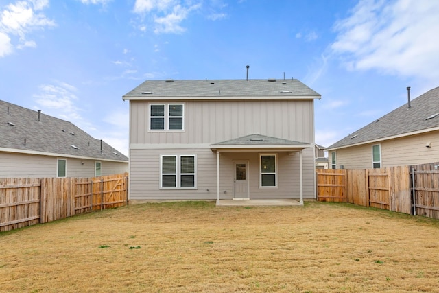 rear view of property featuring a patio and a lawn