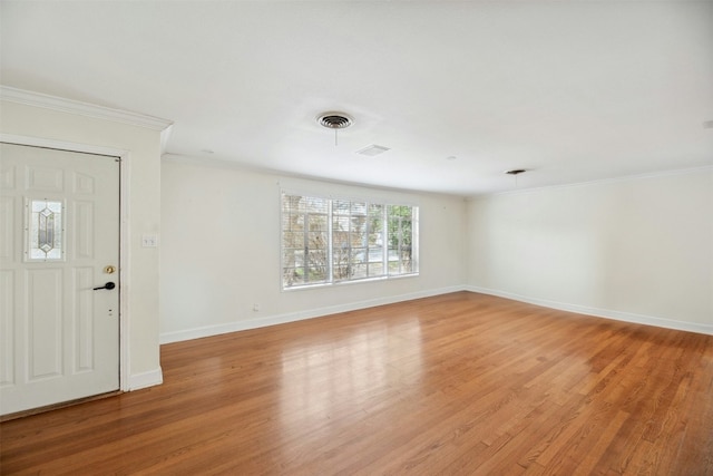 entryway with crown molding and light hardwood / wood-style flooring