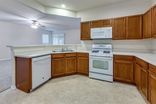 kitchen featuring ceiling fan, sink, white appliances, and kitchen peninsula