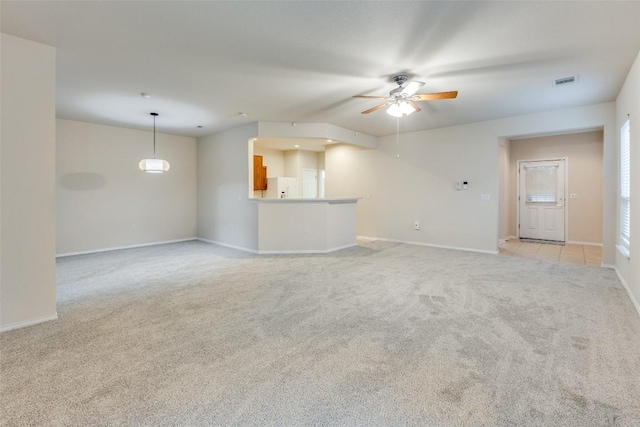 unfurnished living room with light carpet and ceiling fan