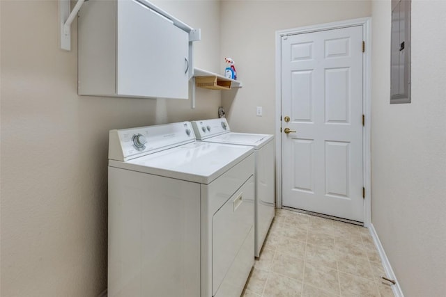 clothes washing area with electric panel, washing machine and dryer, and light tile patterned floors