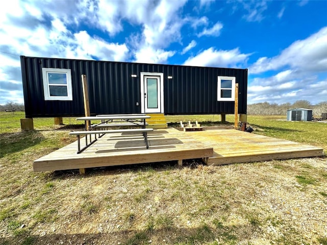 exterior space with a deck and an outdoor structure