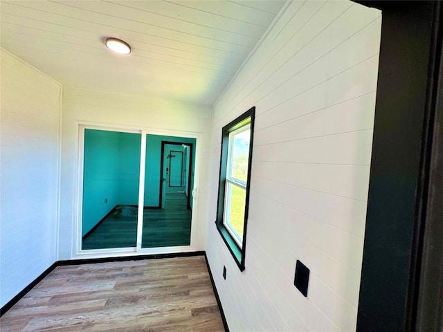 interior space with baseboards and wood finished floors