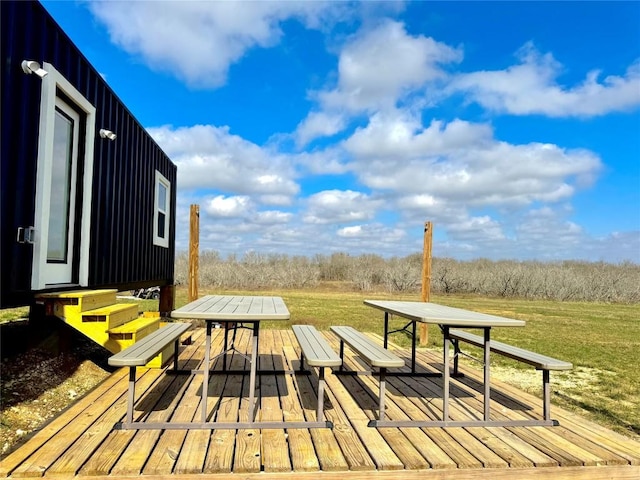 exterior space featuring outdoor dining area and a yard