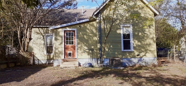 back of house with central AC