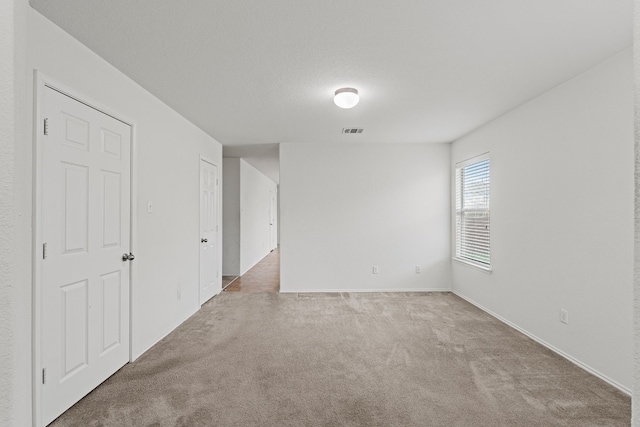 unfurnished room with light colored carpet