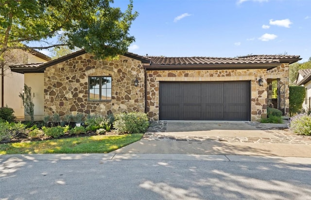 mediterranean / spanish house with a garage