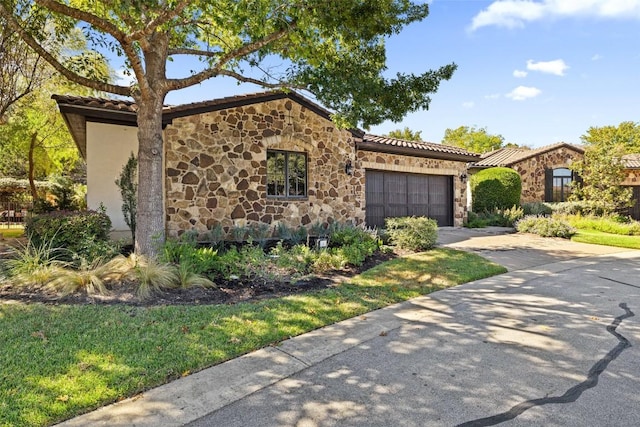 mediterranean / spanish-style house with a garage