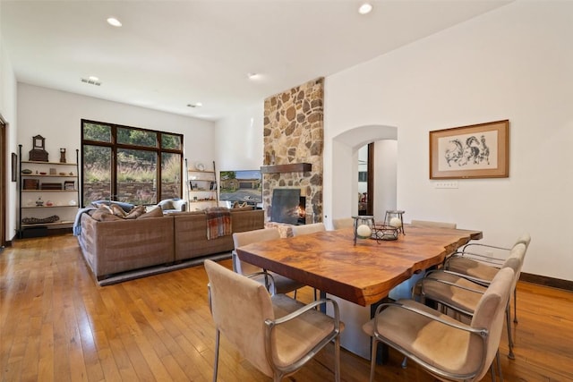 dining space featuring a fireplace and light hardwood / wood-style floors