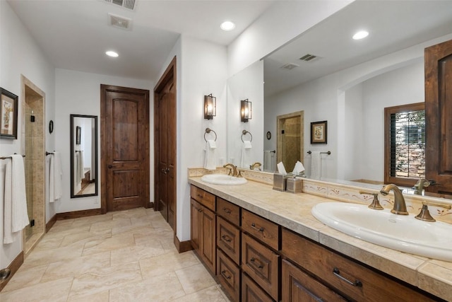 bathroom featuring vanity and an enclosed shower