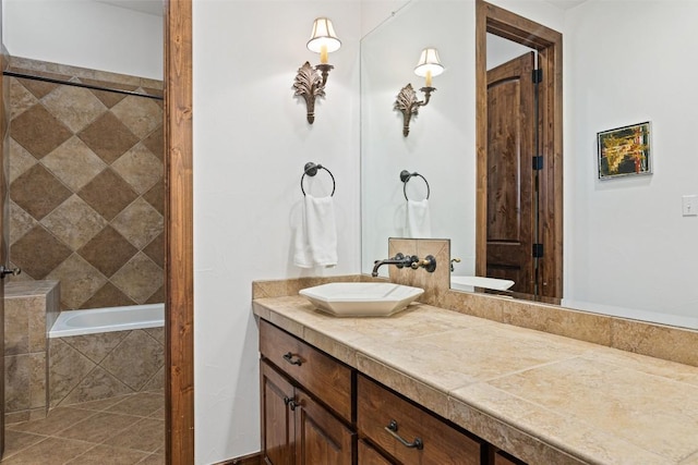 bathroom featuring vanity and tiled bath