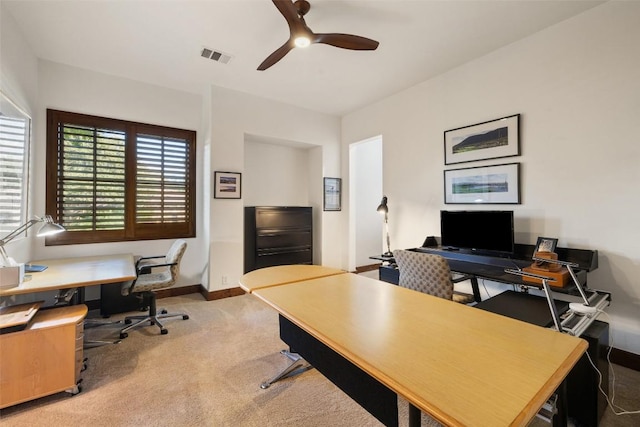 carpeted office space featuring ceiling fan