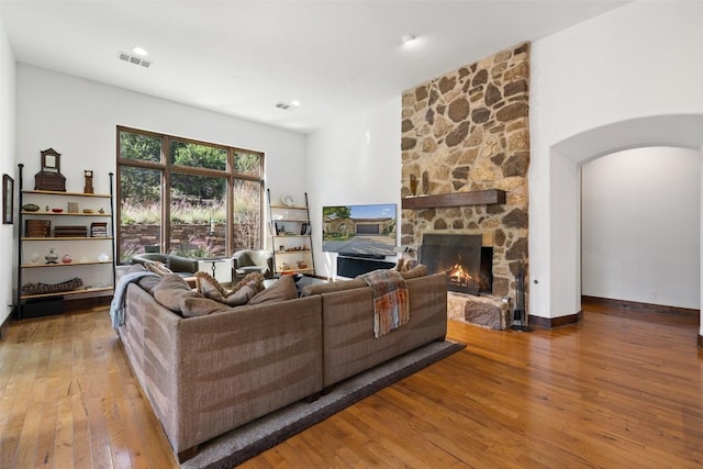 living room featuring a fireplace and wood-type flooring