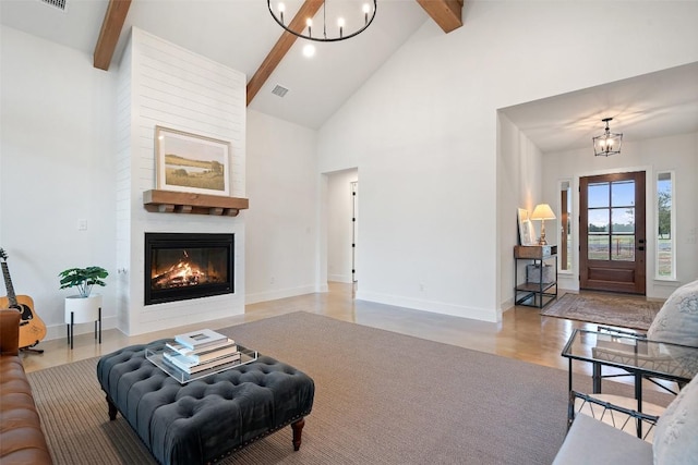 320 Spencer Ct, Fredericksburg, TX 78624 - living room featuring beamed ceiling, high vaulted ceiling, a large fireplace, and a chandelier