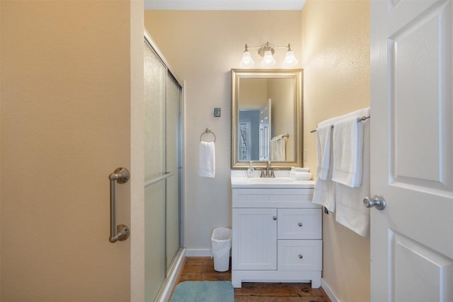 bathroom with vanity and a shower with shower door